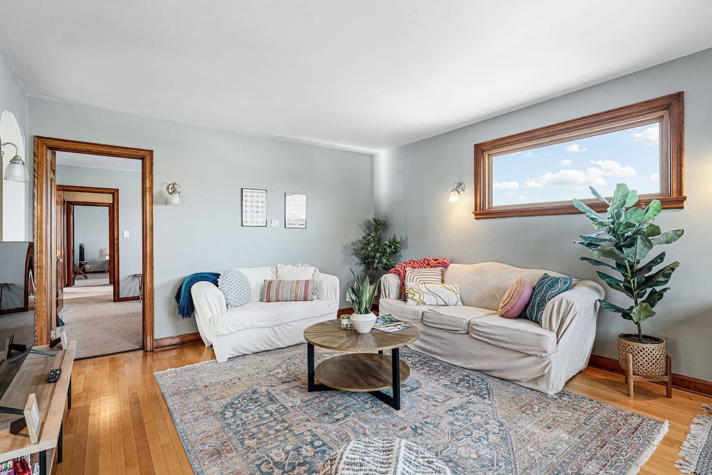 Bright Rail Street Retreat living room with two sofas and an upper-floor window